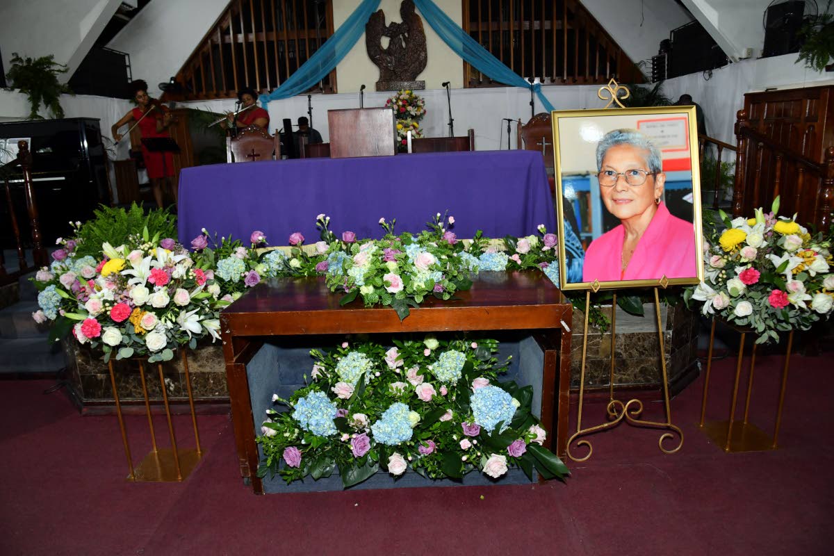 A floral tribute and portrait of Doris ‘May’ Berry, founding director of Mayberry Investments Limited, during her funeral on Monday at Webster Memorial United Church. 