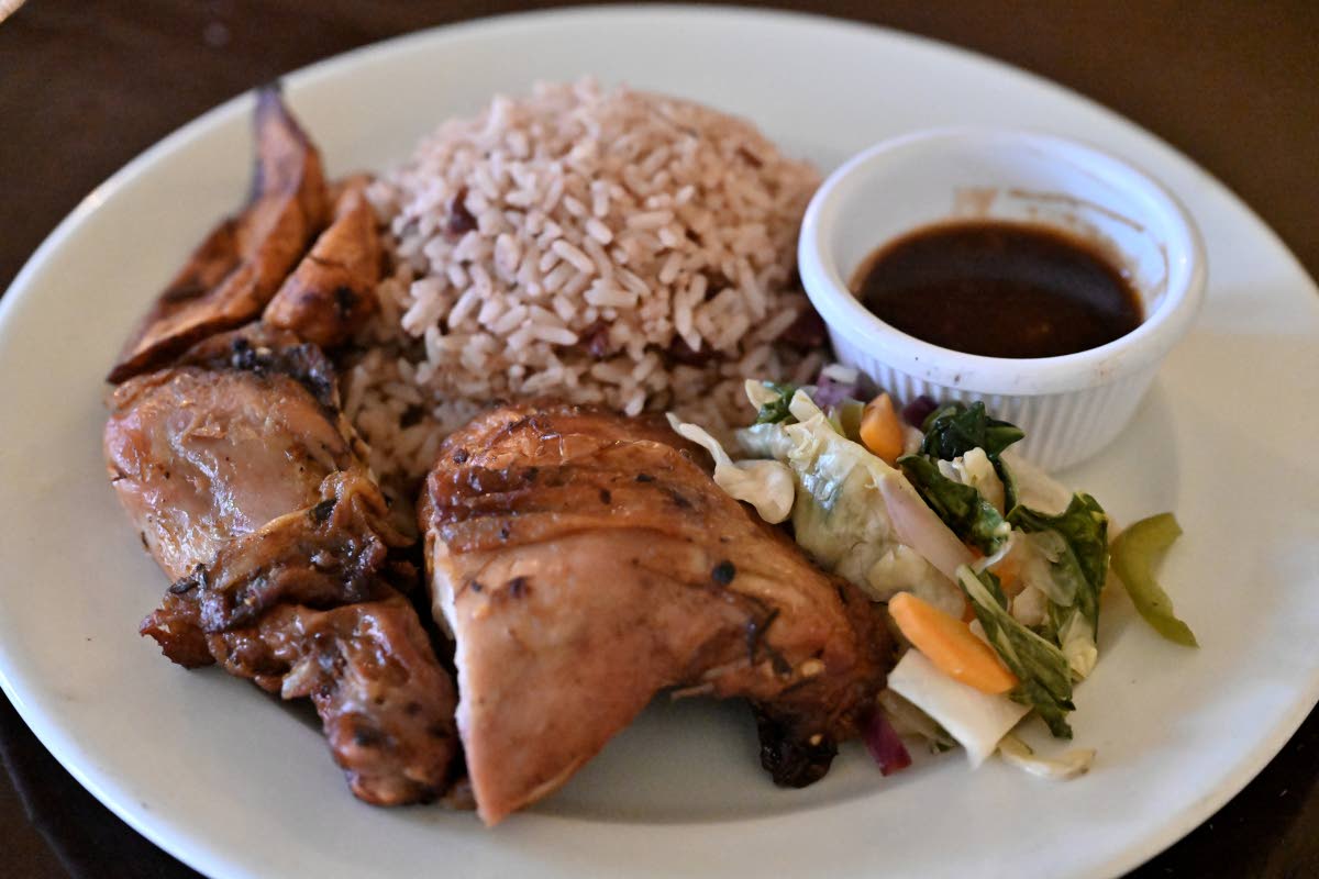 The herb-roasted chicken is paired with traditional rice and peas, and steamed vegetables.