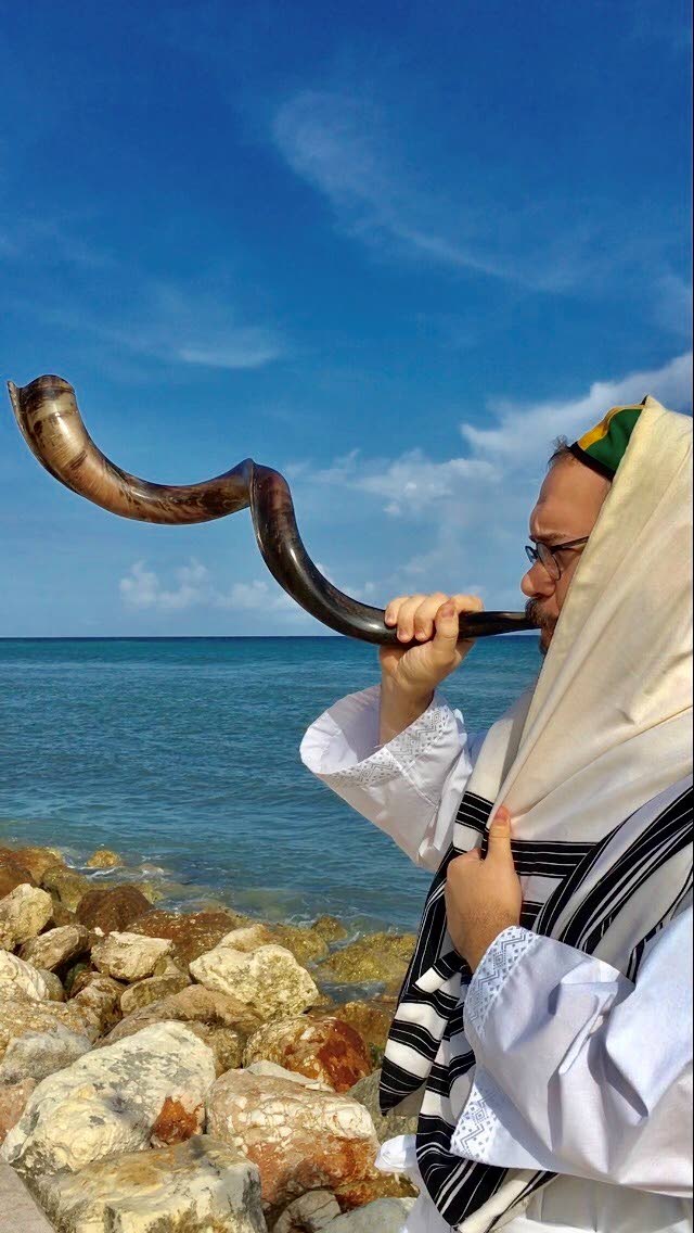 Jamaica’s rabbi sounds the ram horn known as the shofar.