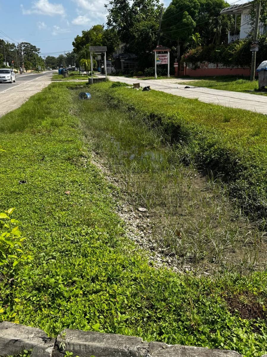 
A neglected drainage system, a broken garbage bin and scattered refuse in a section of Negril.