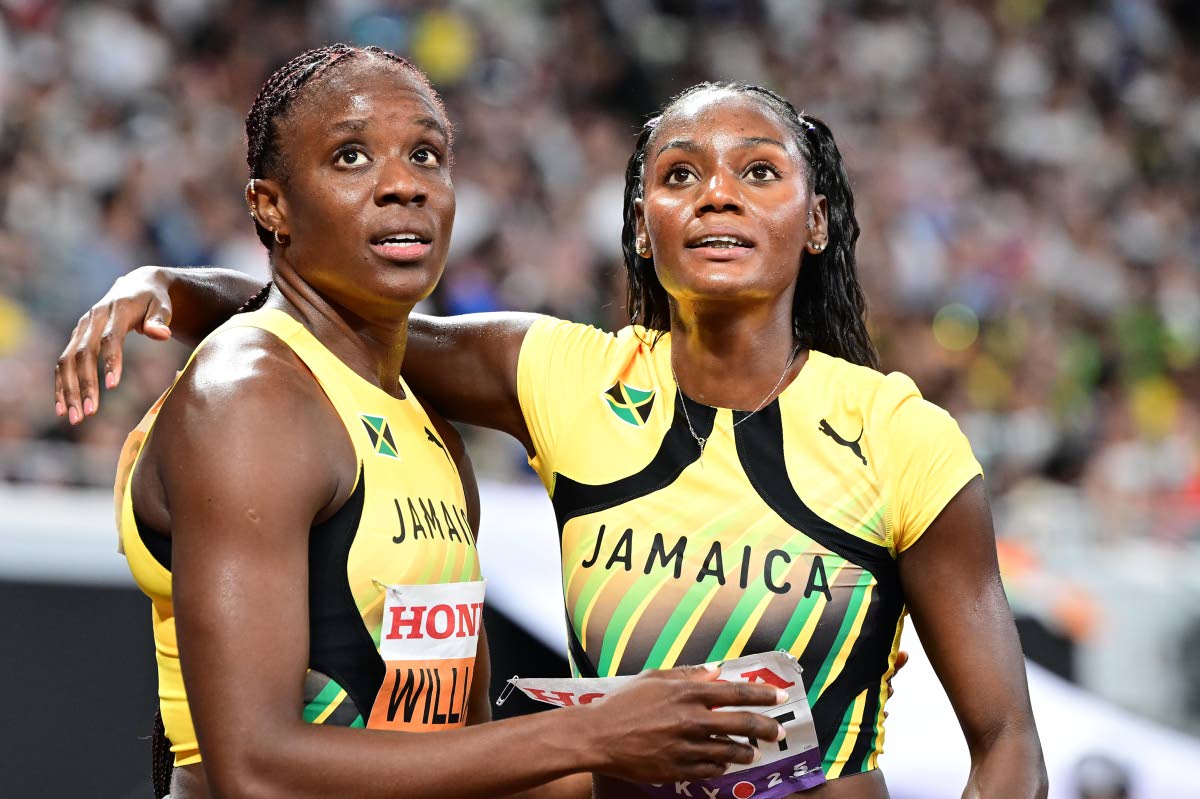Jamaica’s Danielle Williams (left) and teammate Ackera Nugent hug as they await the possibility of qualification to the final of the women’s 100 metres at the World Athletics Championships inside the Japan National Stadium in Tokyo yesterday. Williams 