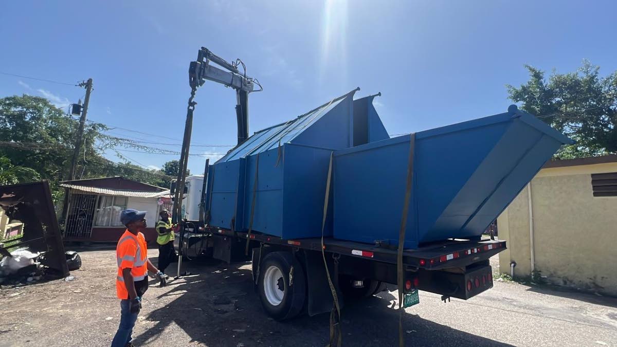 Workmen placing the skips strategically for easy access by business owners, locals and others in the Negril bus park