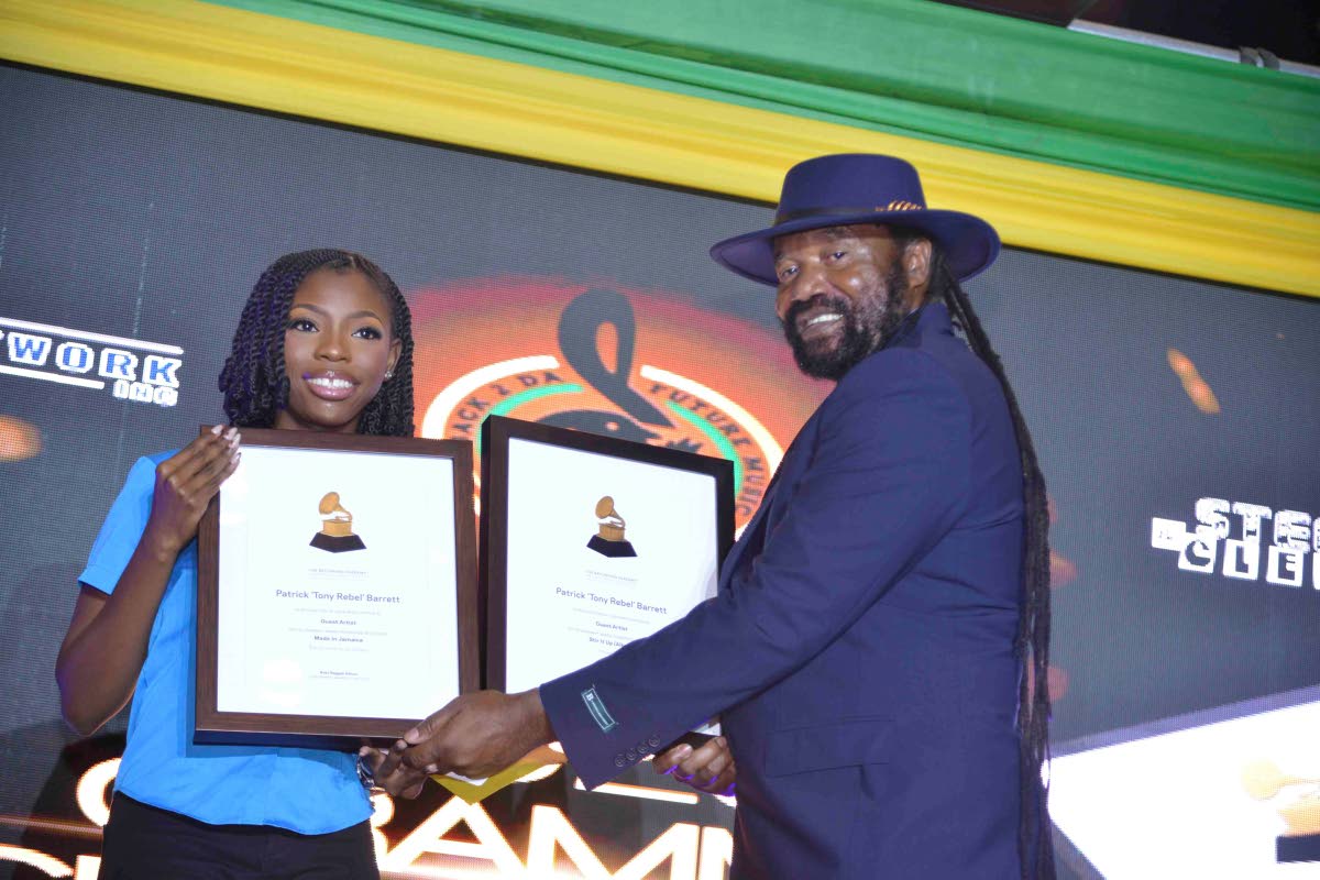 An elated Tony Rebel receives his awards.