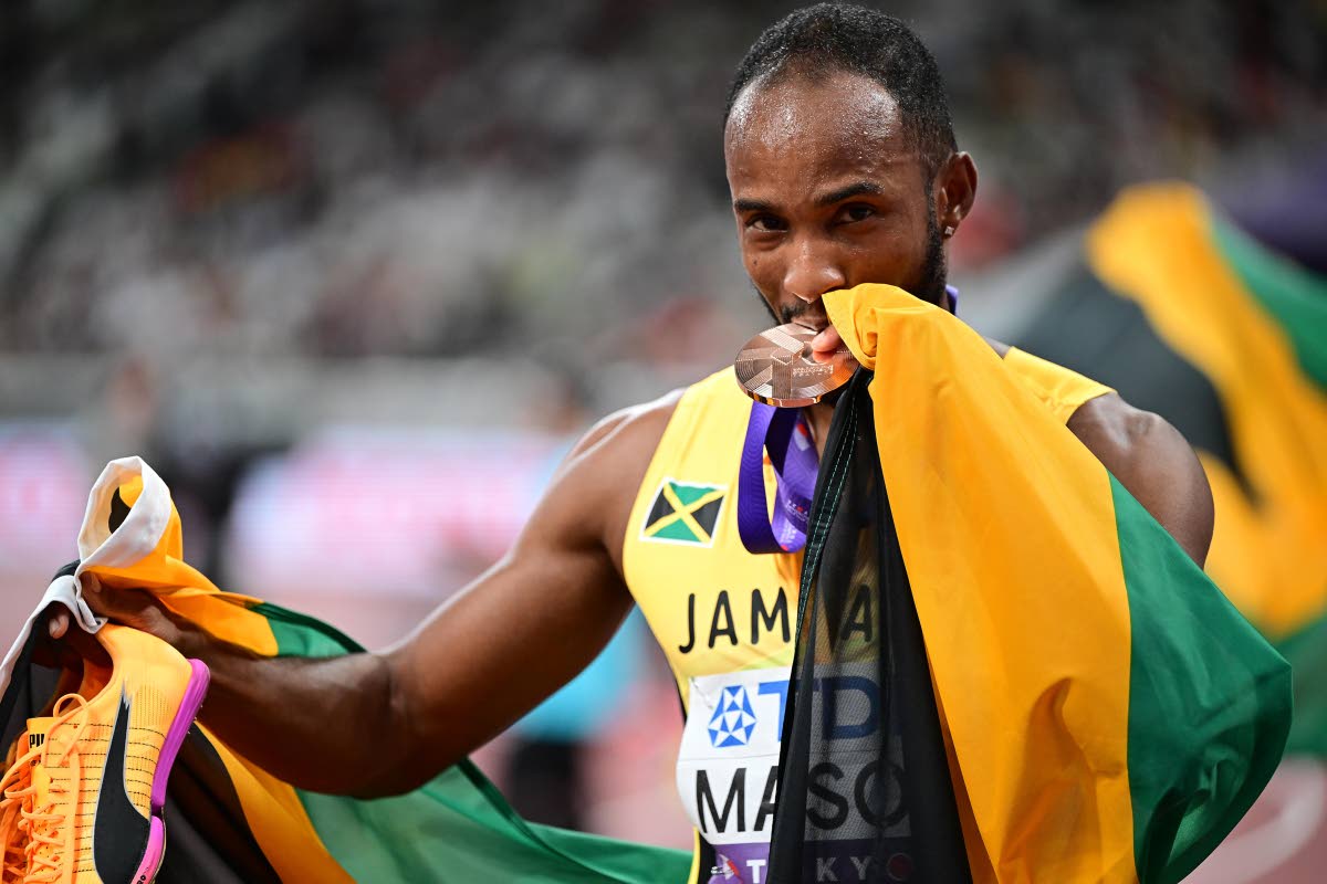 An over-the-moon Tyler Mason checks the authenticity of the bronze medal he won from his participation in the World Athletics Championships 110-metre hurdles inside the Japan National Stadium in Tokyo yesterday.