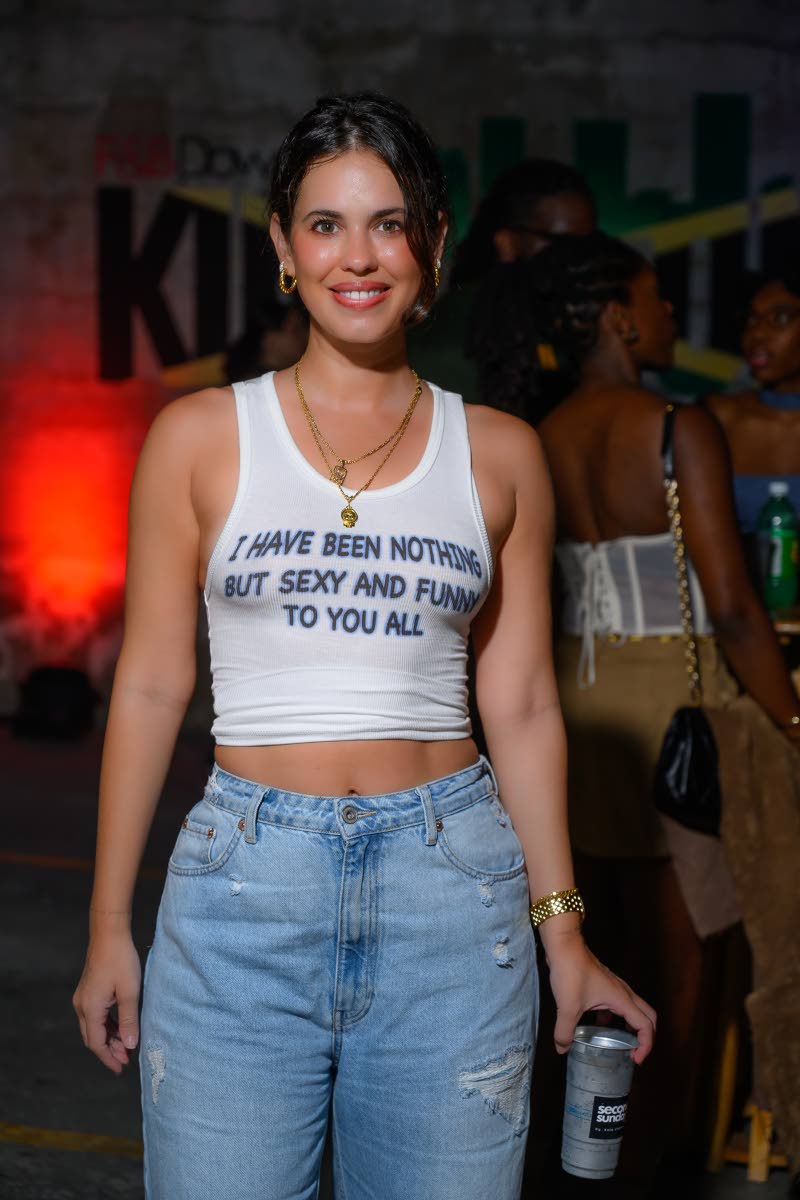 Rosina Casserly keeps it cool in a white tank and denim, letting her shirt do all the talking.