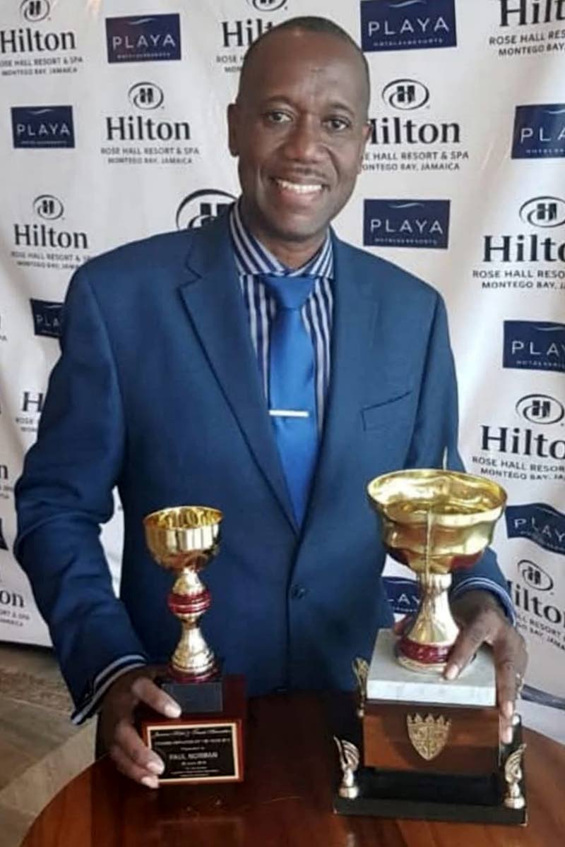 Paul Norman with some of his awards.