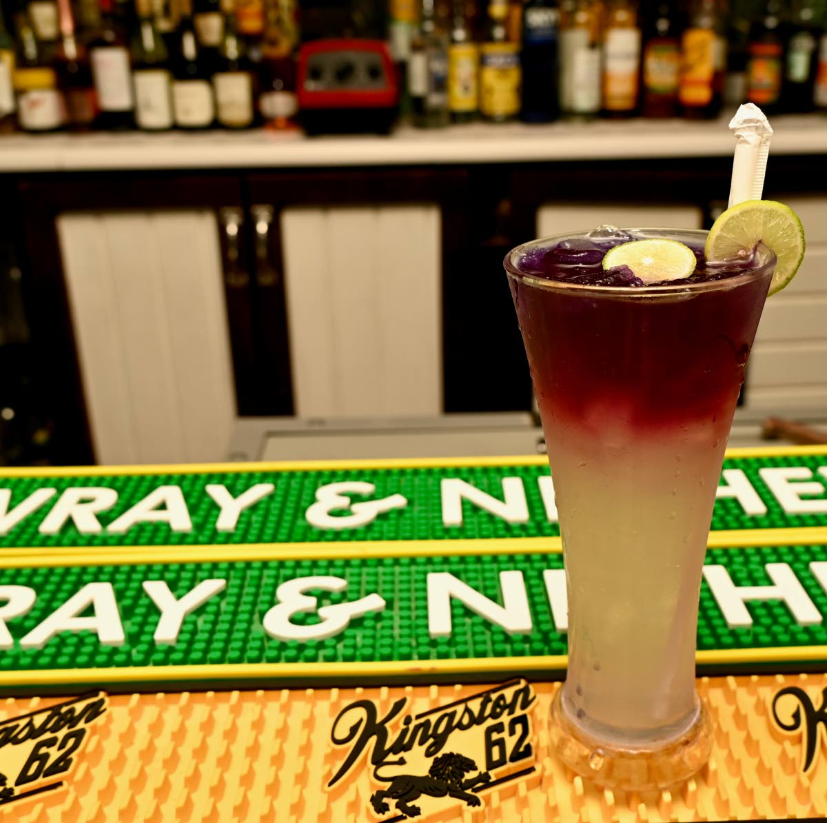 A tall glass of cool lemonade with butterfly pea tea.