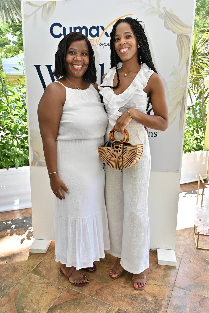 Dr Careen Blair (left), dentist lecturer at the University of Technology, Jamaica, and Carlene Shirley, operations manager, First Regional Credit Union, pair up for a quick photo.