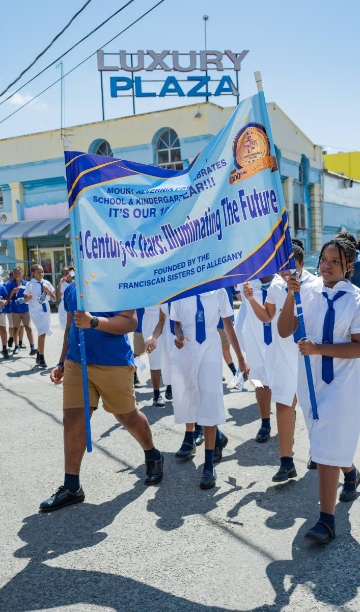 Students of Mount Alvernia Preparatory and Kindergarten march in celebration on Wednesday.