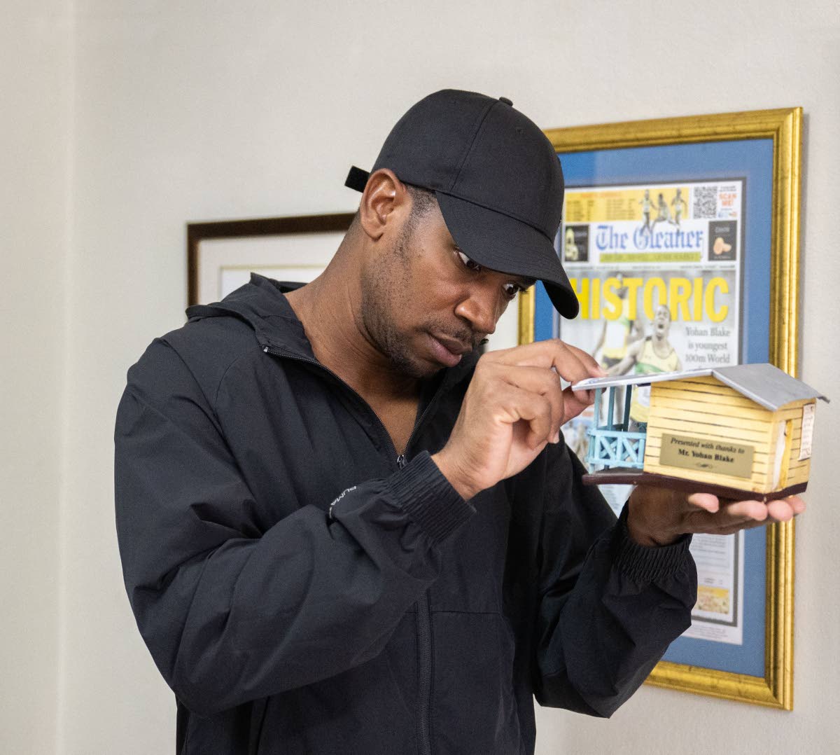
Athlete, entrepreneur and philanthropist Yohan Blake admires one of his many awards received over the years. This one he received for partnering with Food For The Poor to build at least 10 houses annually for families in need.