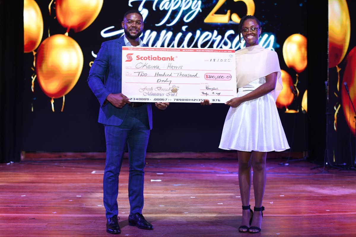 Okeima Harris (right), a recipient of the Bishop Philmon Samuels Scholarship, accepts a cheque valued at $200,000 from Richard Vernon, mayor of Montego Bay, on behalf of the Fresh Bread Ministries International. 