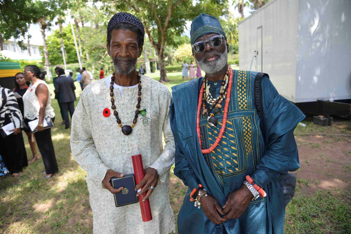 Tim Abayomi Badejo (right) shared that he simply had to be in Jamaica to support his friend Hilbert ‘Berty’ Grant, who received a Badge of Honour for Meritorious Service at the National Honours and Awards ceremony on National Heroes Day.