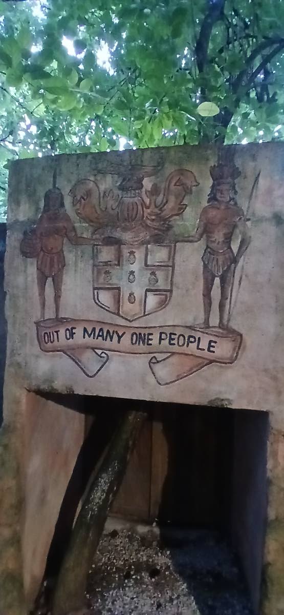 The Jamaica coat of arms is painted on one of the structures at Great Huts Eco Resort in Boston, Portland.