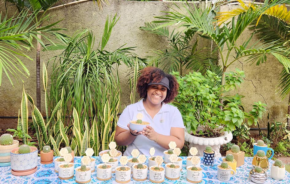 Shara Williams-Lue is all smiles as she poses with one of her potted babies from her Cacti Corner.