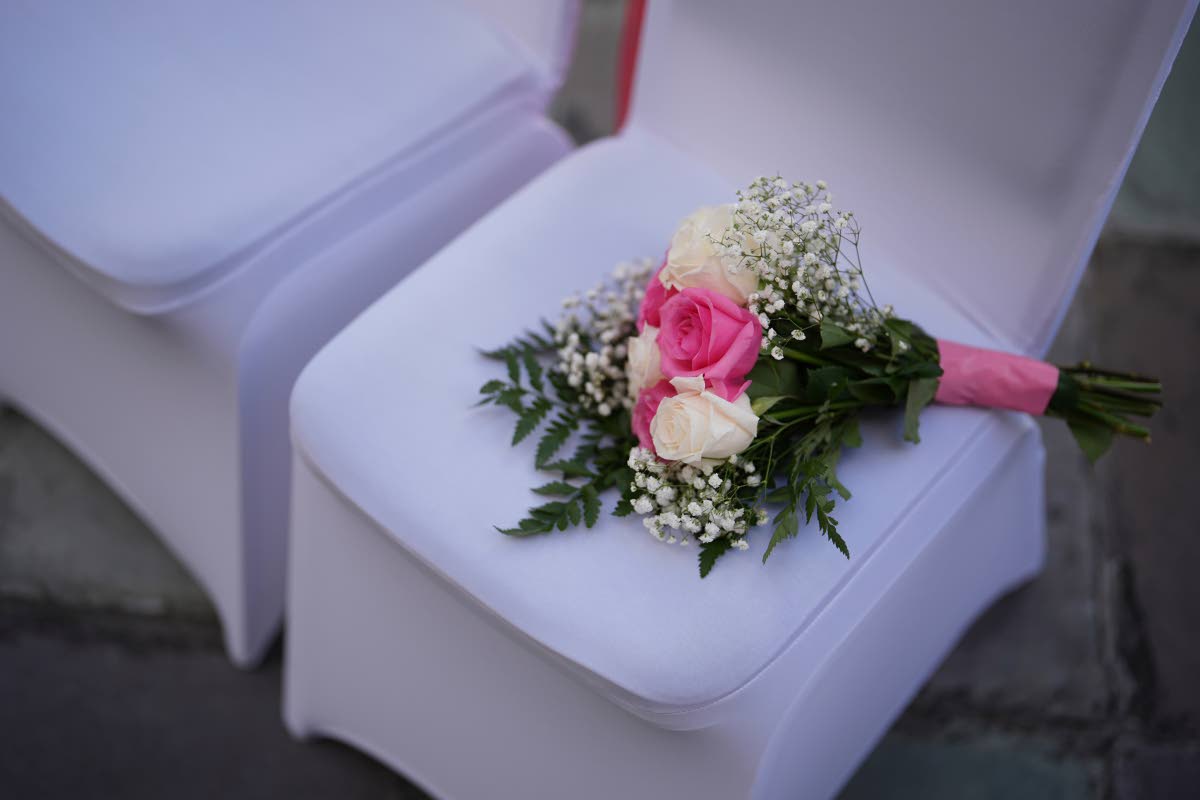 TOP RIGHT: A bouquet of flowers rests on a chair ahead of a Valentine’s Day group wedding ceremony in Miami earlier this year.