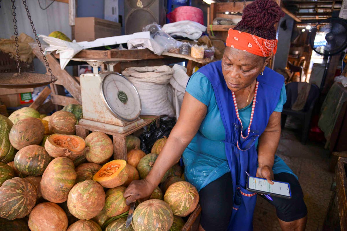Munchun, a market vendor, speaks with The Gleaner in Coronation Market in downtown Kingston yesterday.