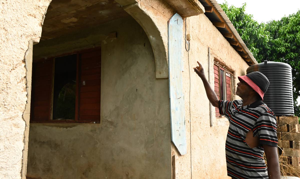 Micah Williams, tomato farmer from Flagaman in St Elizabeth, shows items used to shield him at his home during Hurricane Beryl in 2024.