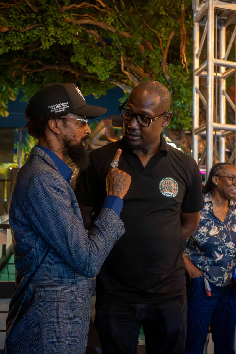 At right, Eton Pearcy of Jam Rock Events and the man behind the Partial Incentives Breakfast Programme, engages Andre St. John more popularly known as Mad Suss. Pearcy is encouraging players in the entertainment industry to get involved in more philanthrop