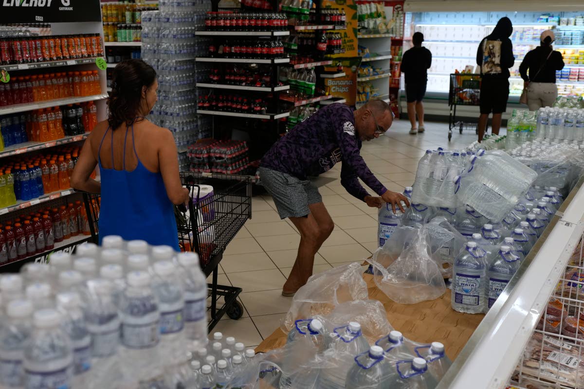 People buying groceries ahead of the forecast arrival of Hurricane Melissa in Kingston.