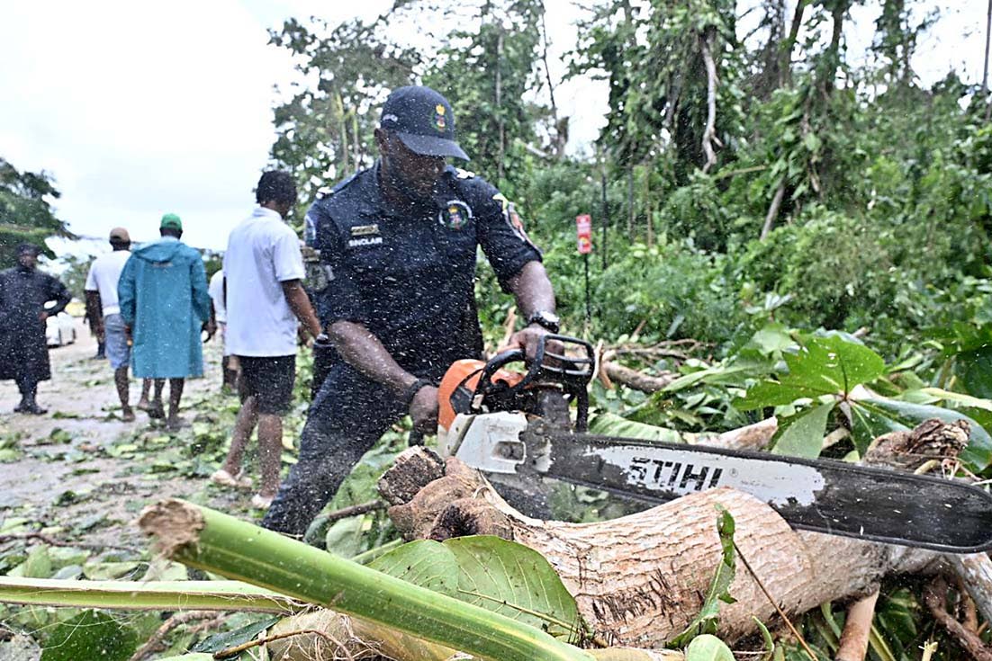 Corporal Dwain Sinclair of the Specialised Operations team, part of a 16-member crew, clearing fallen trees from the Ocho Rios main road after Hurricane Melissa.