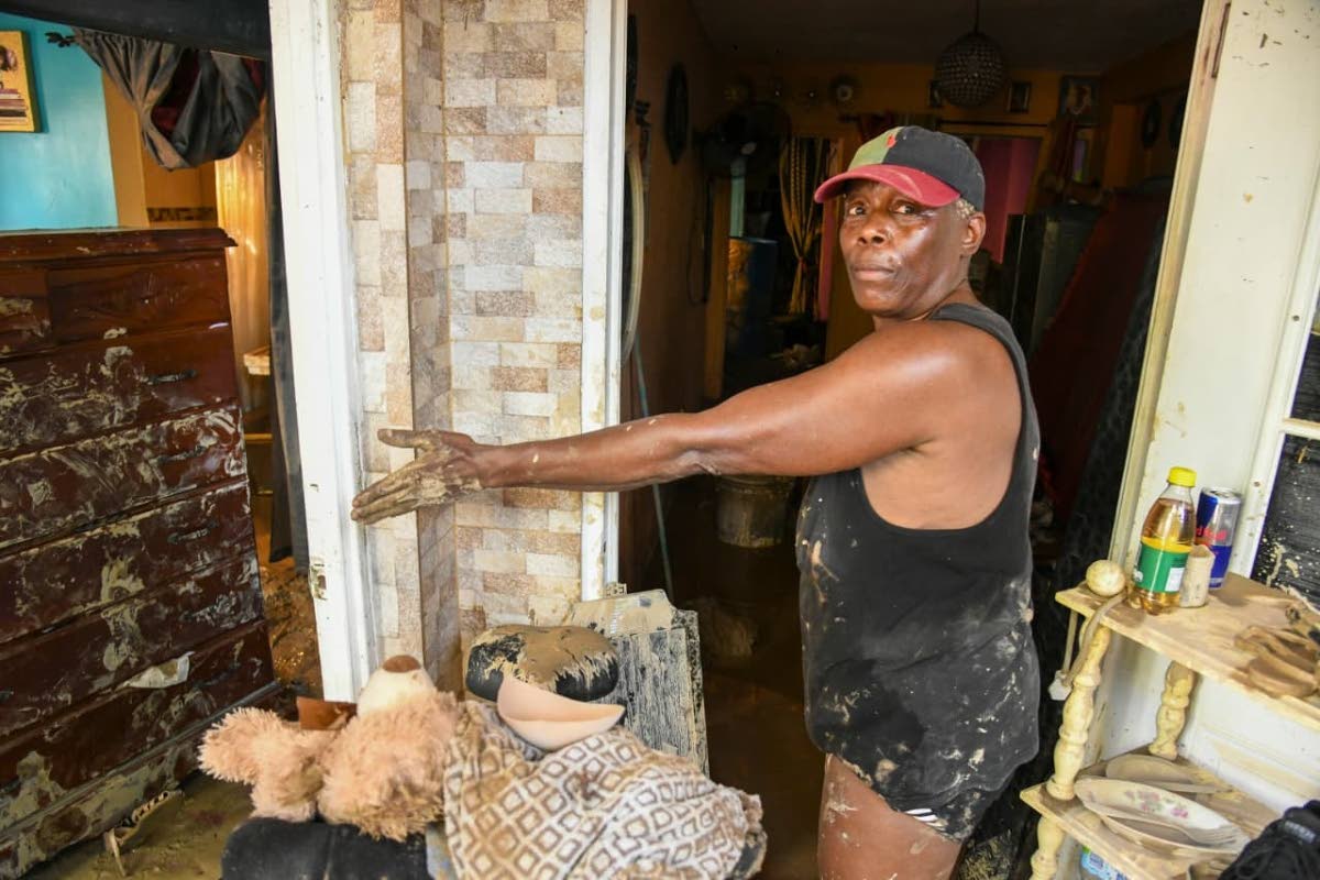 Rose Holness shows the damage to her home in St James. 