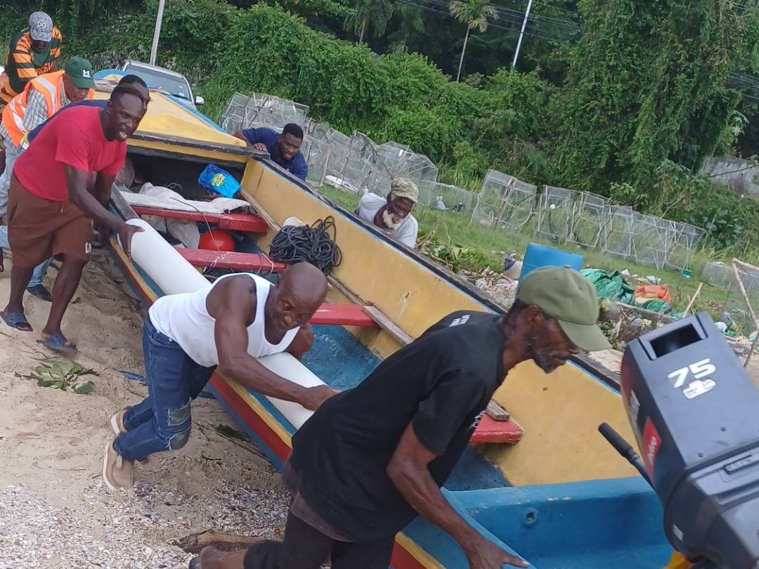 Fishermen at the Ocho Rios Fishing Village in St Ann return boats to the water following the passage of Hurricane Melissa.