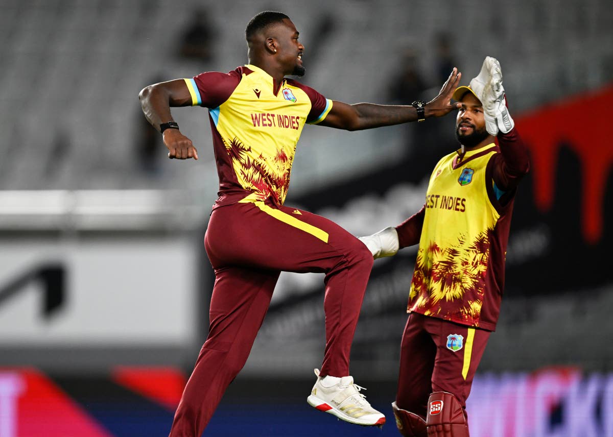 West Indies bowler Jayden Seales (left) celebrates with skipper, Shai Hope after taking the wicket of New Zealand’s Michael Bracewell during the first T20 International between the teams at Eden Park in Auckland, New Zealand, on November 5.