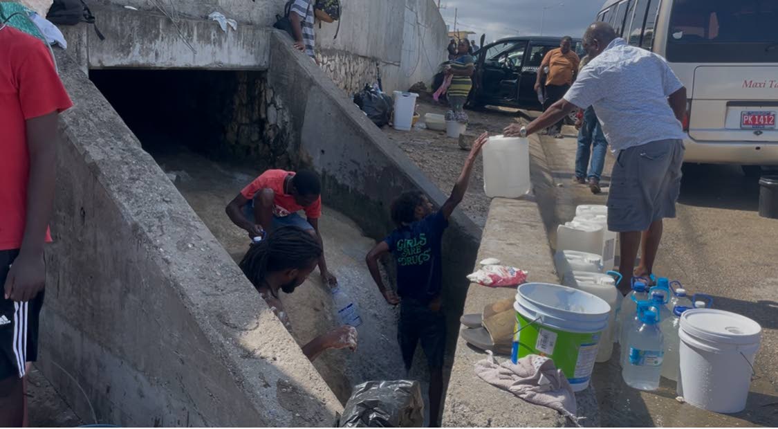 Residents collect water of unknown origin in Montego Bay, St James. 