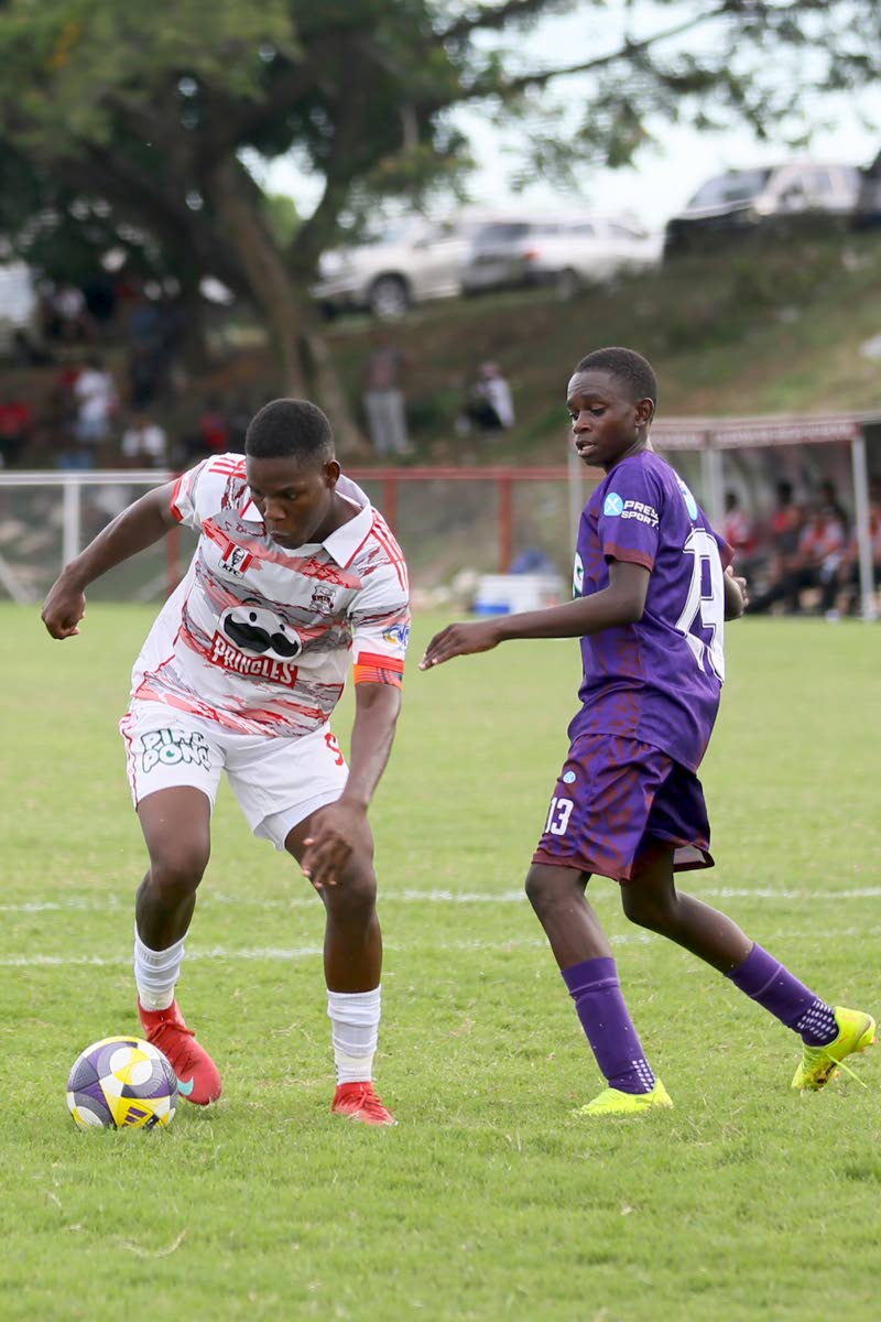 Orane Watson (left) of Glenmuir High dribbles past Rajay Scott of Bustamante High during a daCosta Cup match  on Wednesday, September 10, 2025. 
