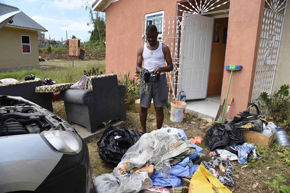 
Arthur Barris, a resident of Phase 2 in The Estuary, cleaning up his house.