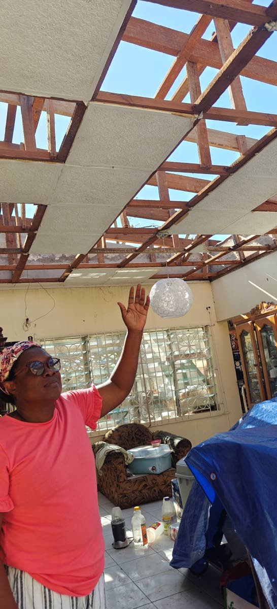 In Lovers Lane, St Elizabeth, Velma Gunter keeps a spirit of praise as she shows her roofless living room where Hurricane Melissa blew off her five-bedroom home roof on October 28.