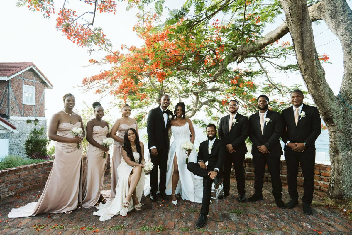 The newly-weds pose happily with their supportive wedding party.