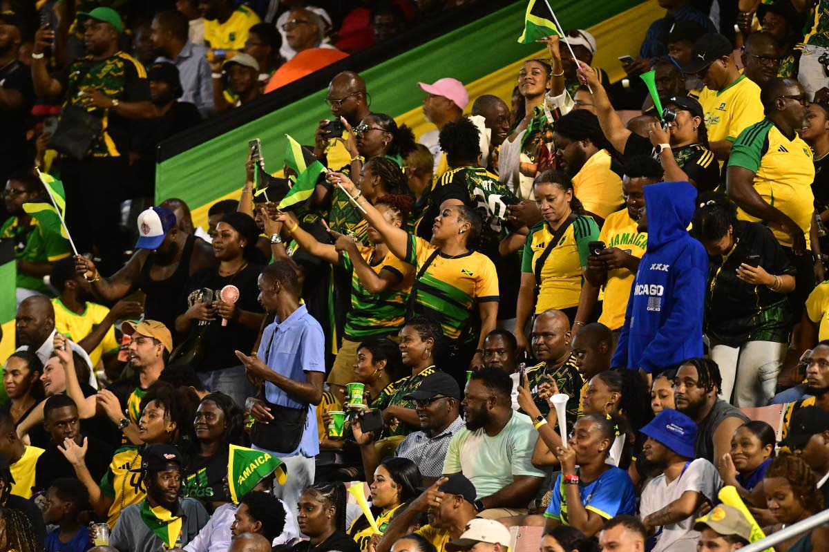 Jamaican football supporters celebrate the fourth goal scored by Dujuan ‘Whisper’ Richards during the Concacaf World Cup Qualifying football match at the National Stadium in Kingston on Tuesday. The Reggae Boyz thrashed Bermuda 4-0.
