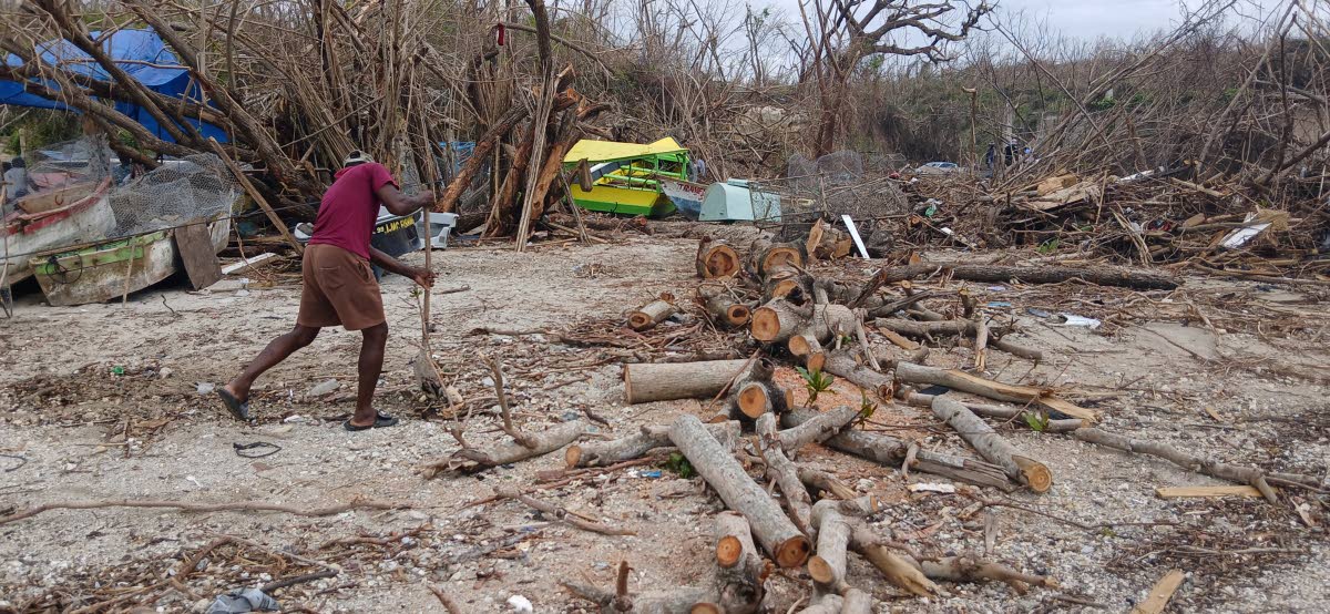 A fisherman cleans up the beach at Border fishing village on Tuesday.