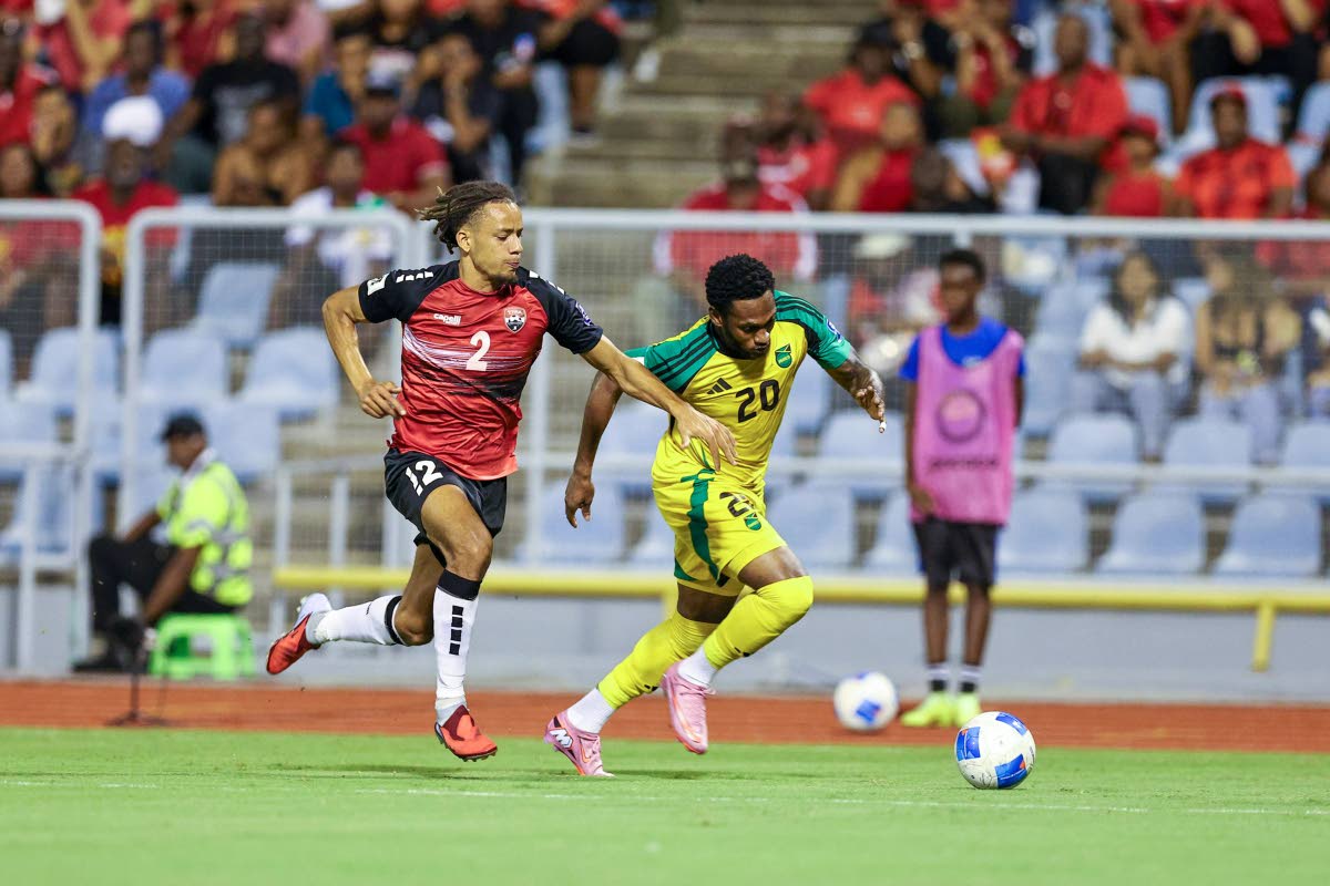 Courtesy of concacaf.com 
Renaldo Cephas dribbles by Trinidad and Tobago’s Deron Payne during their Concacaf World Cup Qualifier at the Hasely Crawford Stadium on Thursday.