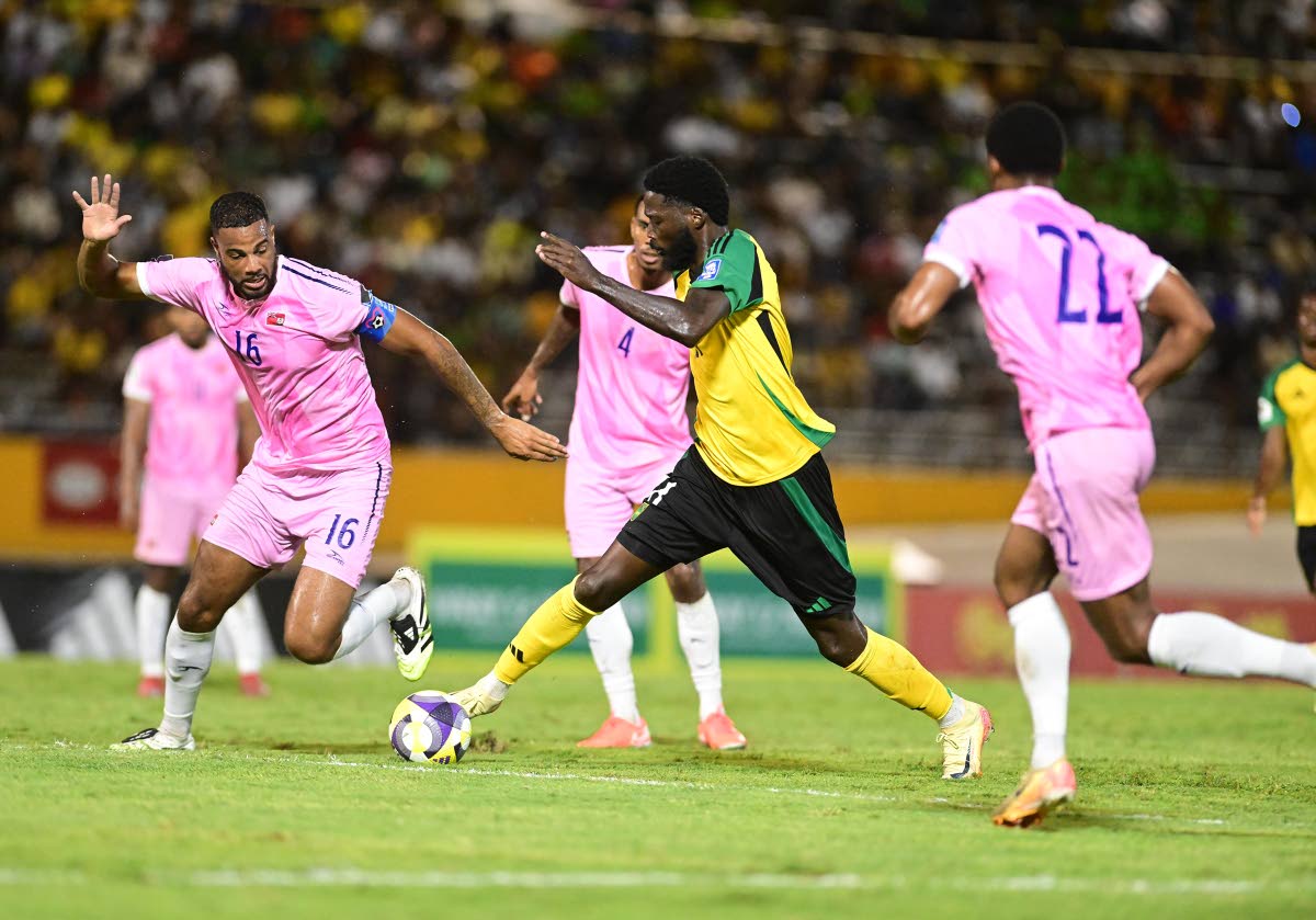 Reggae Boy Shamar Nicholson (second from right) in action against Bermuda’s Dante Leverock (left) during the Jamaica versus Bermuda World Cup Qualifier at the National Stadium  on Tuesday, October 14. 