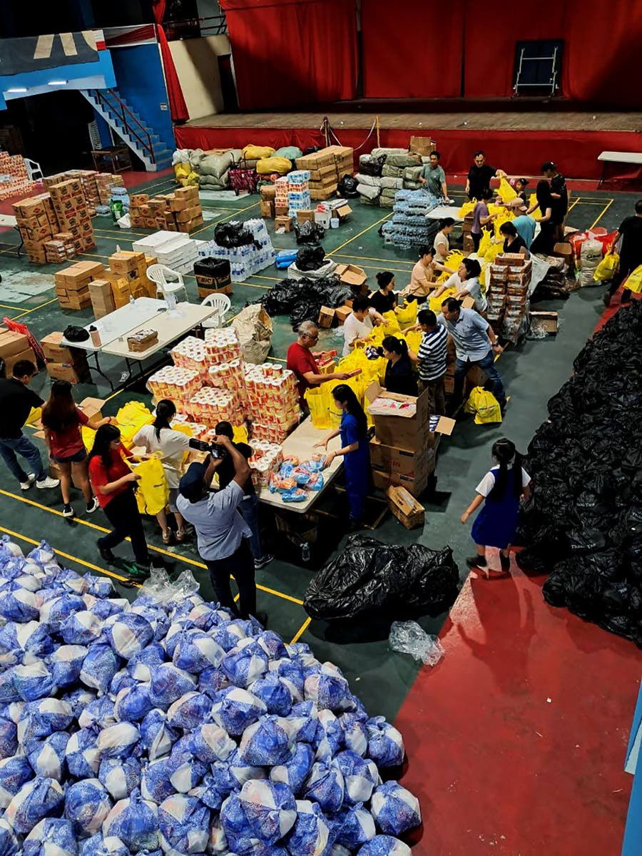 The Jamaican Chinese Benevolent Association, in partnership with the Chinese Community of Jamaica, packages relief items for communities affected by Hurricane Melissa.