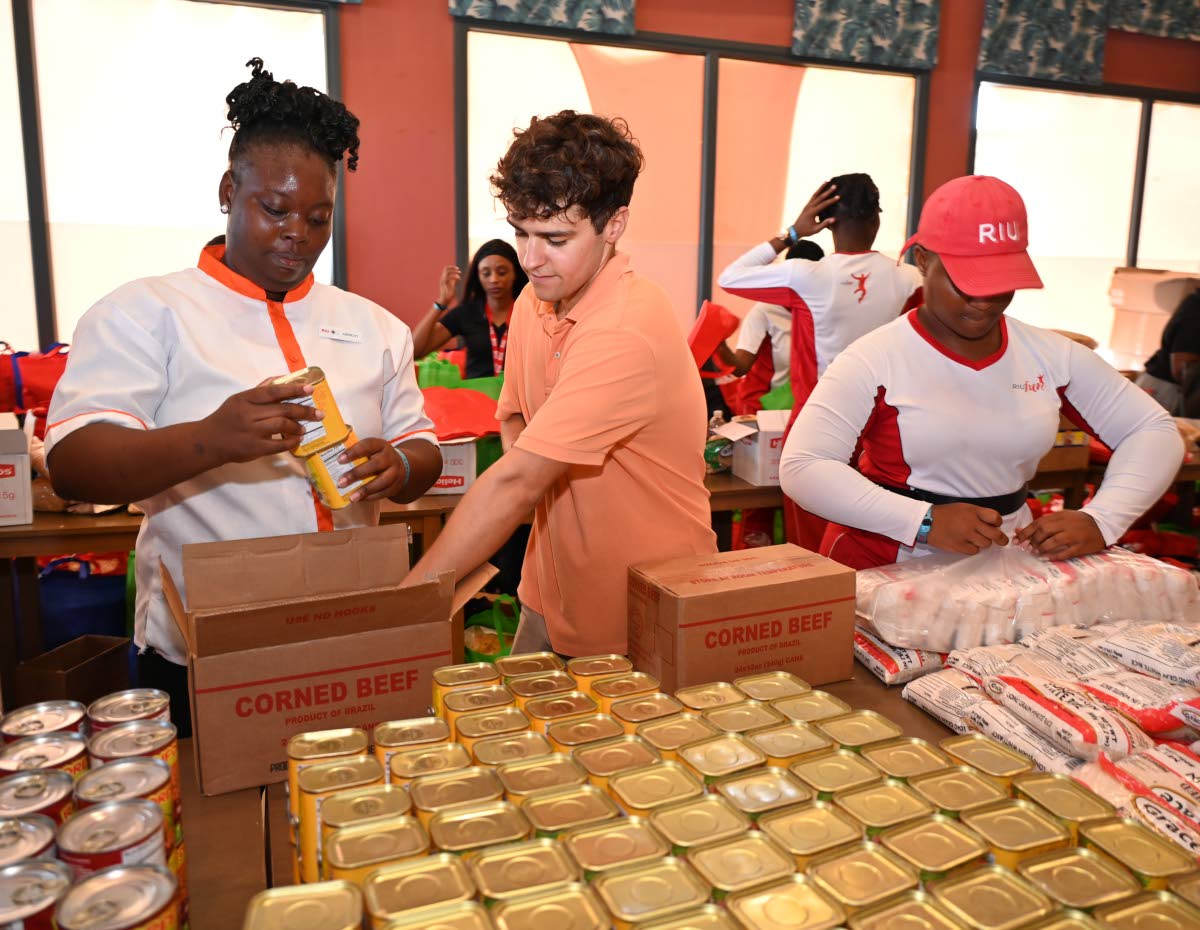 From left: RIU Montego Bay’s Abbigay Nelson, Jorge Carrion, assistant purchasing manager, and Charollette Gibson prepare care packages for team members on Wednesday.