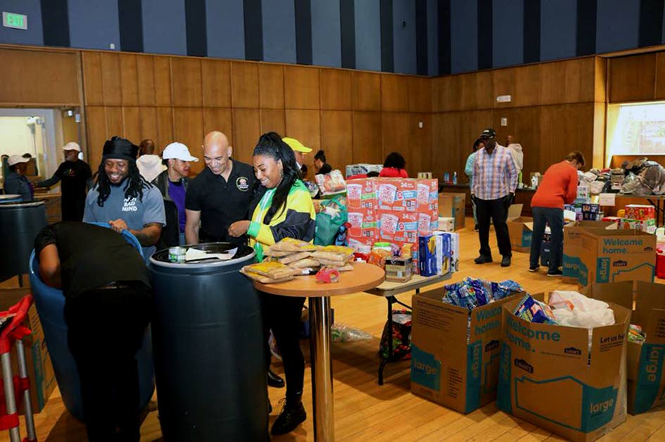 Jamaica’s Ambassador to the United States, Major General (Ret’d) Antony Anderson joins volunteers in packing relief supplies at the Embassy of Jamaica main sorting hub at the Silver Spring Civic Building Veterans Plaza in downtown Silver Spring, Maryla