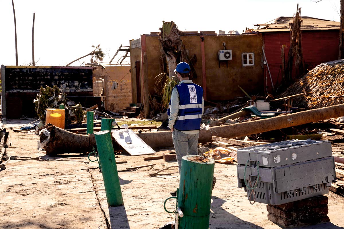 A UNDP team member assesses damage in Parottee, St Elizabeth, following Hurricane Melissa.