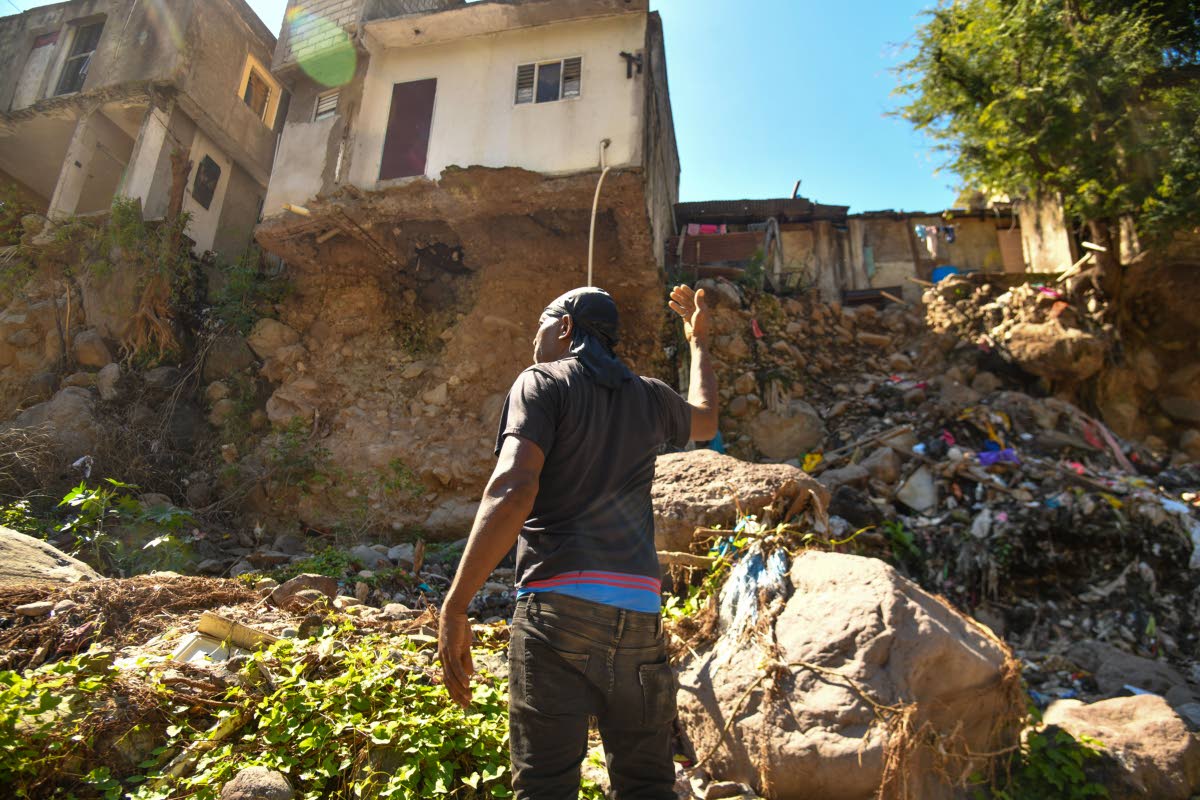 Mark Jackson, a resident of Tavern, St Andrew, highlights the dangerous erosion caused by the swollen Hope River.