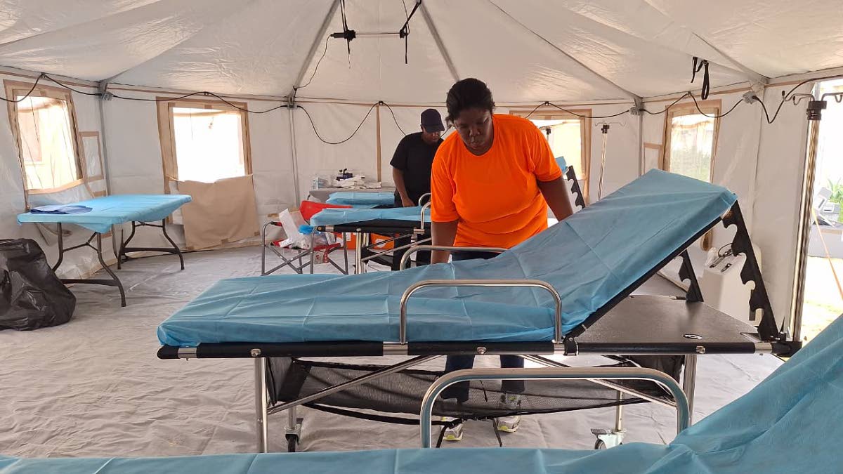 The Barbados Defence Force team preparing beds on one of several wards in the field hospital.
