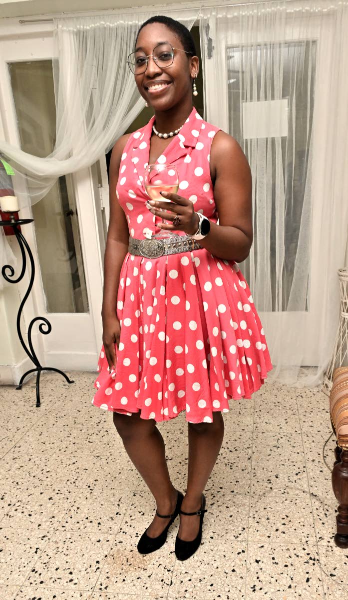 Ifa-Shani Dehaney dons a sleeveless polka-dot collared dress.