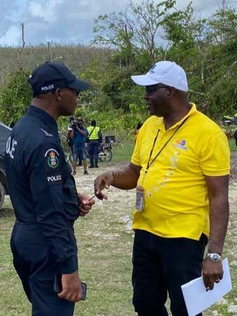 Gary Allen (right), RG CARES Foundation chairman, discusses logistics with Det Cpl Ronald Bowen during the outreach visit, reflecting the close collaboration between the foundation, law enforcement and the church in serving affected communities.