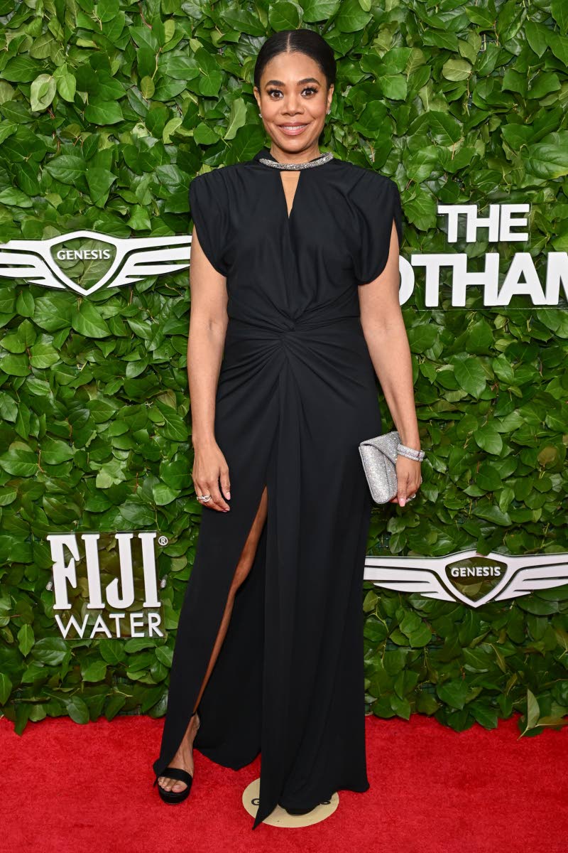 Regina Hall dons a black V-neck thigh-slit gown. 