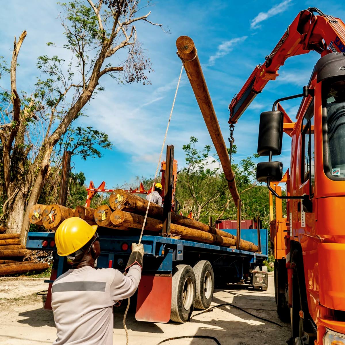 A JPS lineman raises a utility pole as crews work to restore power in St James.
