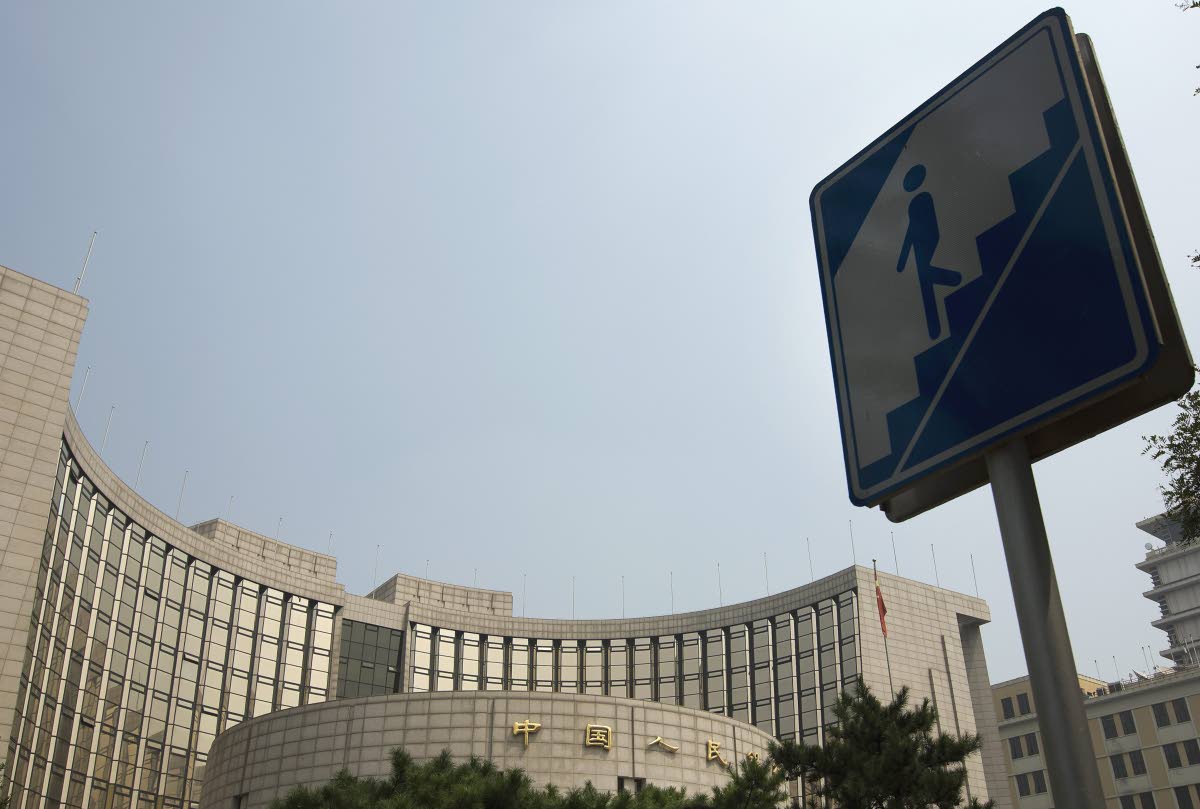 In this August 11, 2015 photo, an underpass tunnel sign stands nearby the People's Bank of China in Beijing.