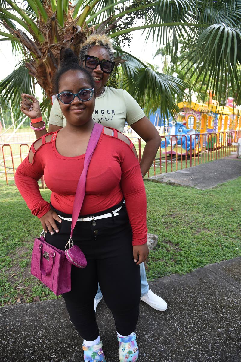 Yvonne Smith Tracey (background) poses with her daughter Sekaai Tracey during the Digicel Foundation Christmas treat for special needs children.