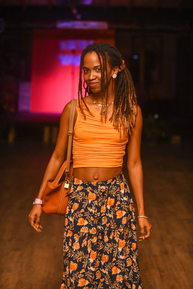 Tiffani Barrett shows off her relaxed style in a floral maxi skirt and orange one-shoulder crop top.