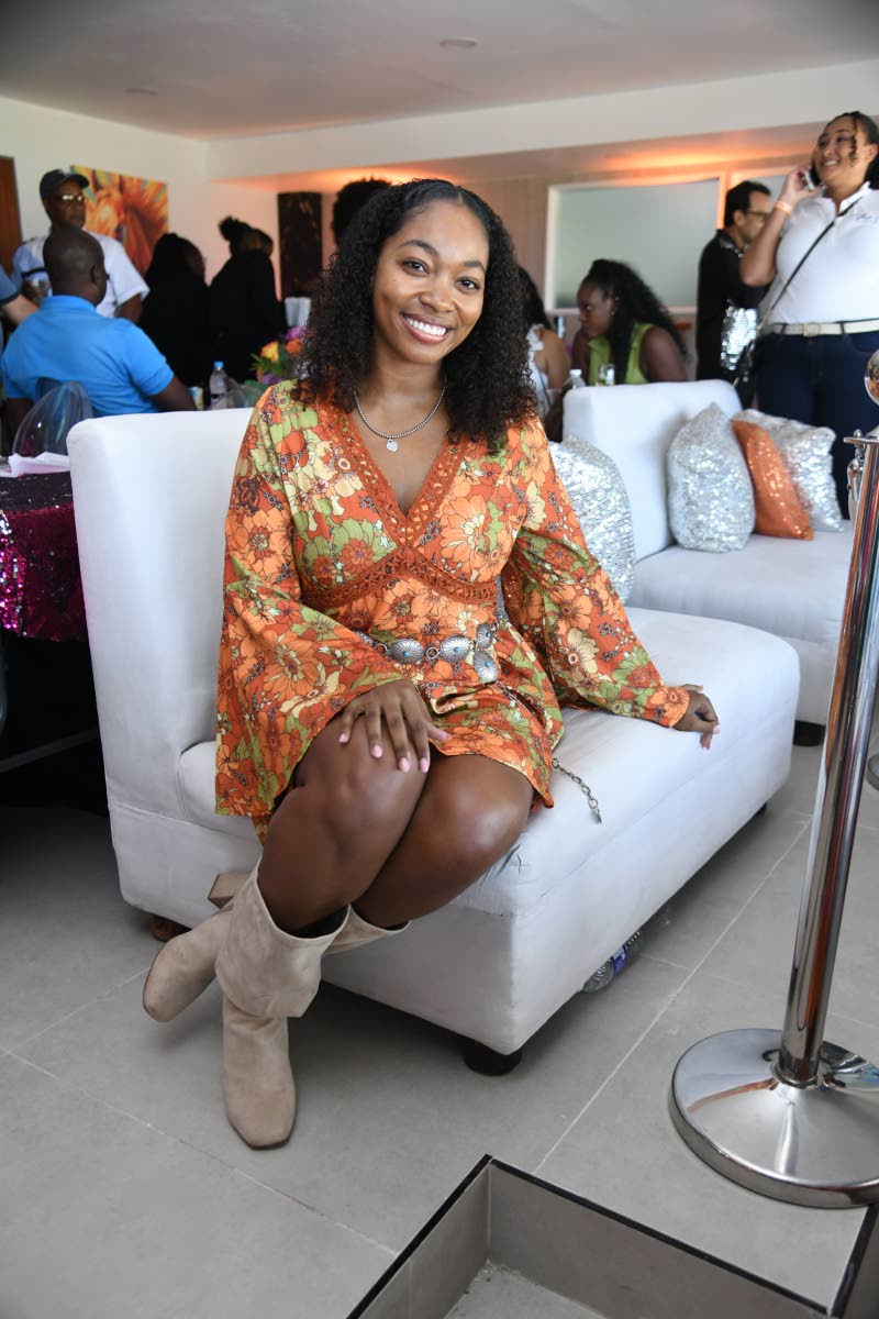 Right: Sporting a radiant smile to match the sunny race day, Iyana Stewart-Gaynor sits pretty in her hippie-inspired dress and high boots. 